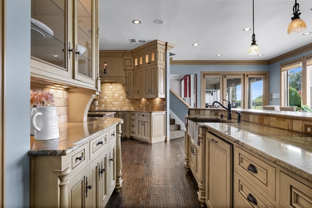 kitchen with ornamental molding, backsplash, decorative light fixtures, light stone countertops, and dark hardwood / wood-style floors