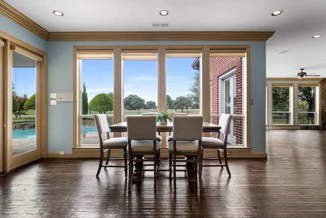 dining space featuring crown molding, ceiling fan, and dark hardwood / wood-style flooring