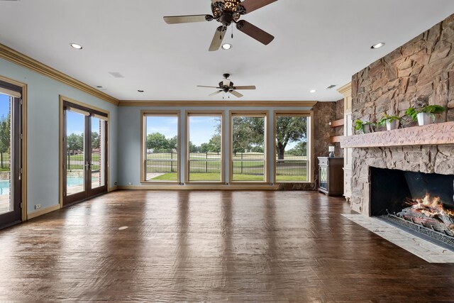 unfurnished living room with ceiling fan, a fireplace, dark hardwood / wood-style floors, and ornamental molding