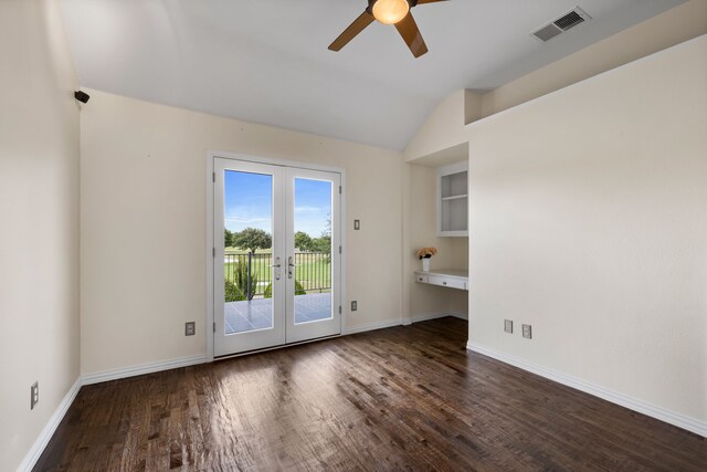 empty room with french doors, ceiling fan, dark hardwood / wood-style floors, and vaulted ceiling