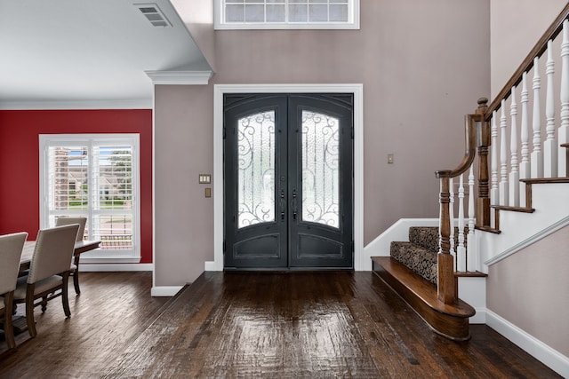 entrance foyer featuring crown molding, french doors, and dark hardwood / wood-style floors