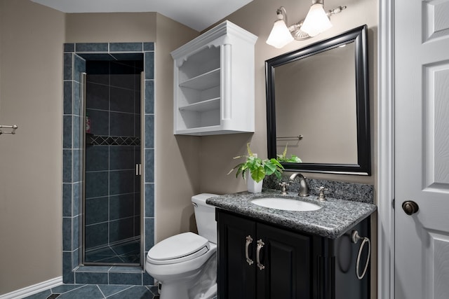 bathroom featuring vanity, toilet, tile patterned floors, and walk in shower