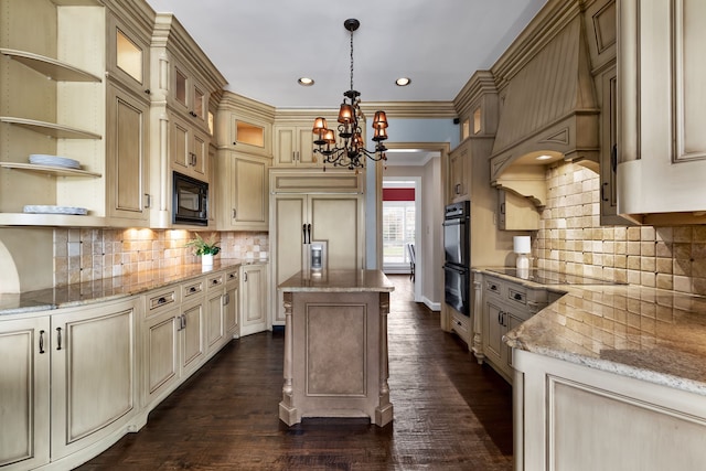 kitchen with dark wood-type flooring, decorative light fixtures, light stone counters, and a center island