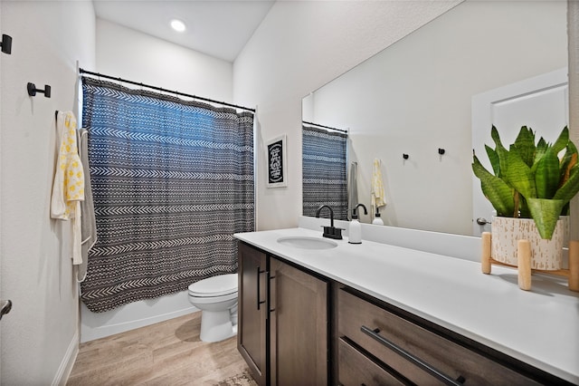 full bathroom with vanity, toilet, hardwood / wood-style flooring, and shower / bathtub combination with curtain