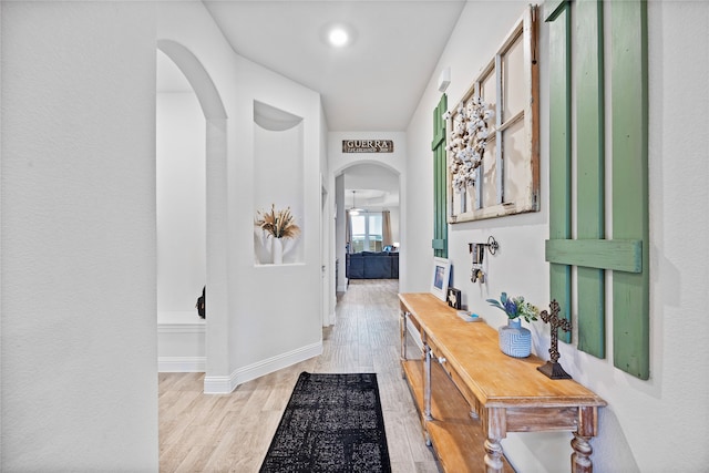 corridor with light hardwood / wood-style floors