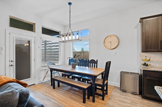 dining space with light hardwood / wood-style flooring