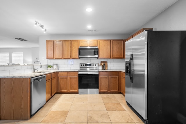 kitchen with stainless steel appliances, sink, backsplash, and light tile patterned flooring