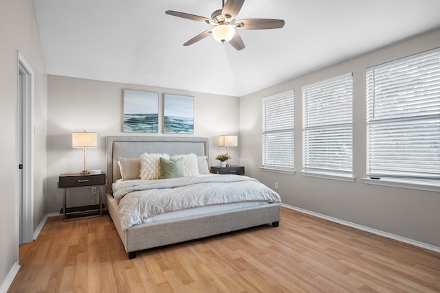 bedroom with lofted ceiling, ceiling fan, and light hardwood / wood-style floors