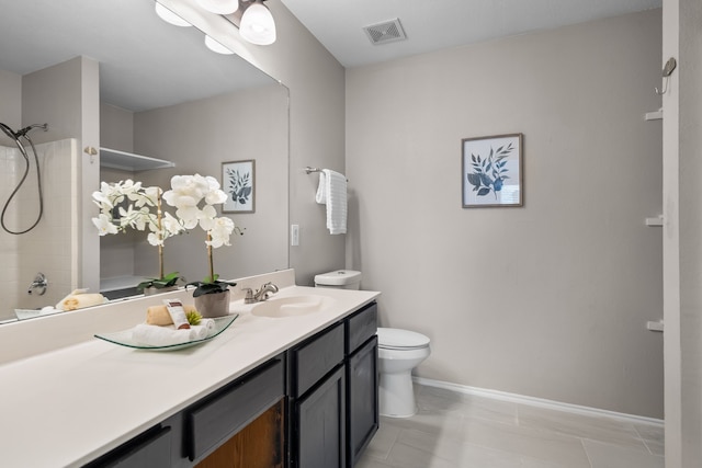 bathroom featuring vanity, toilet, and tile patterned flooring