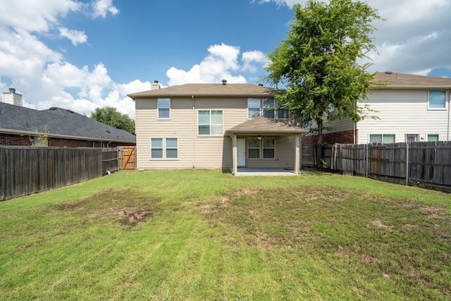 back of property featuring a lawn and a patio