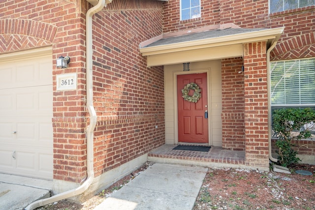 view of exterior entry with a garage