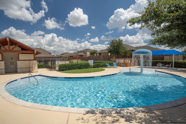 view of swimming pool featuring pool water feature and a patio