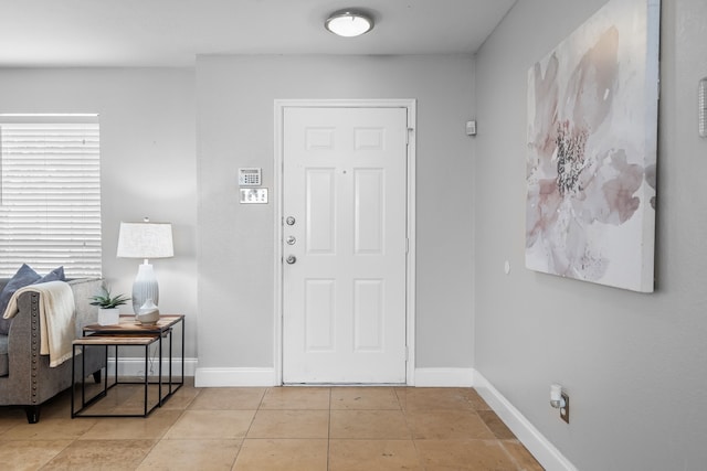 foyer entrance with light tile patterned floors