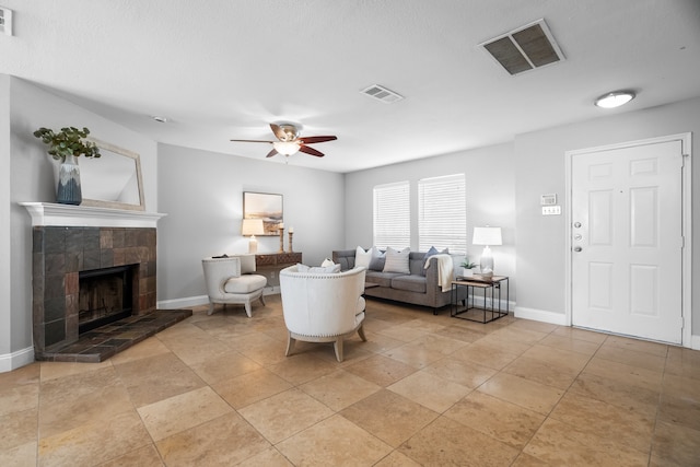 living room featuring a fireplace and ceiling fan