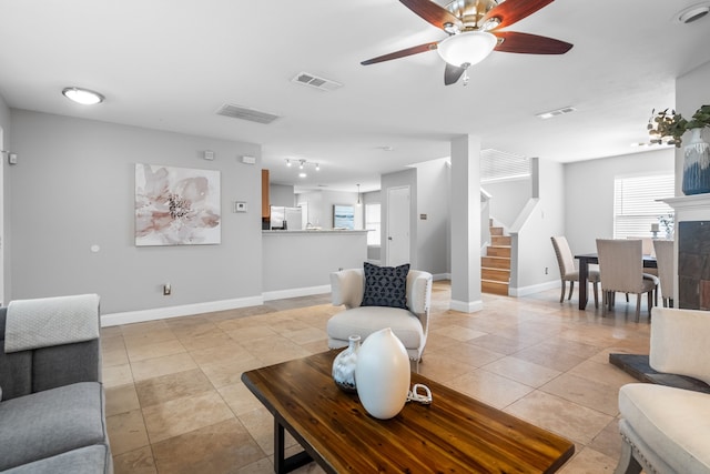 living room with ceiling fan, light tile patterned floors, and a fireplace