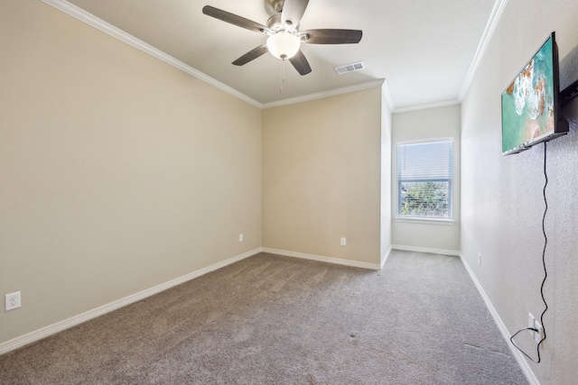 spare room featuring crown molding, carpet floors, and ceiling fan