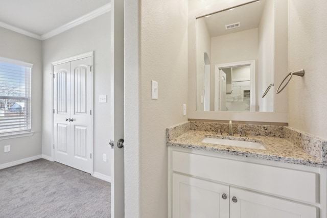 bathroom featuring crown molding and vanity