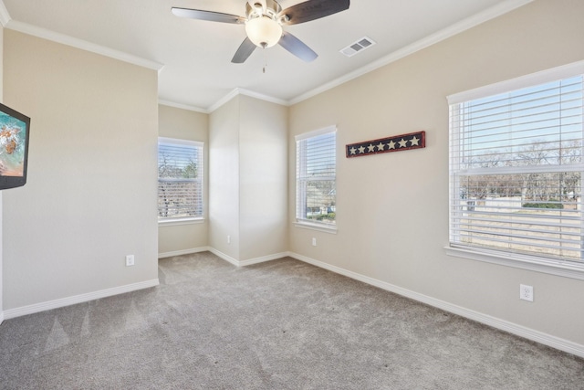 spare room with crown molding, ceiling fan, and light carpet