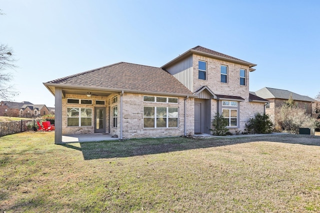 back of house with a patio area and a lawn