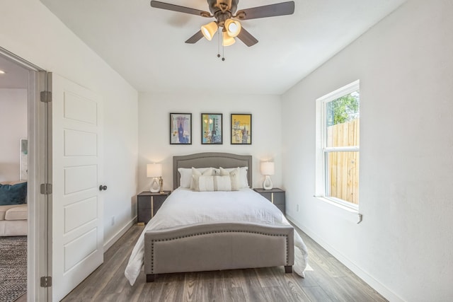 bedroom with ceiling fan and dark hardwood / wood-style floors