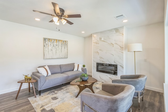 living room with ceiling fan, dark hardwood / wood-style floors, and a high end fireplace