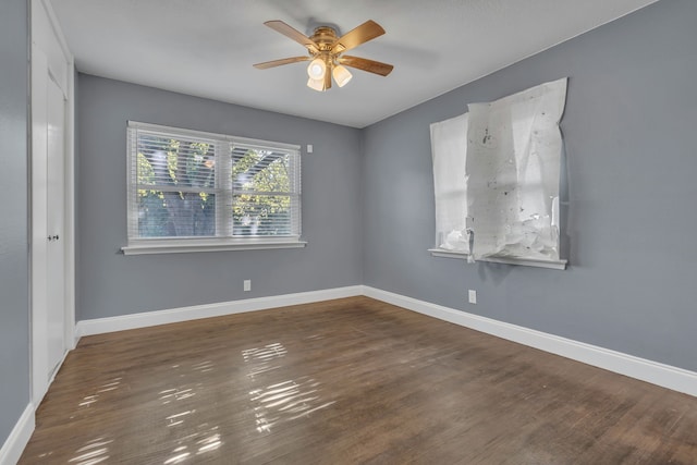 unfurnished room featuring ceiling fan and dark hardwood / wood-style floors