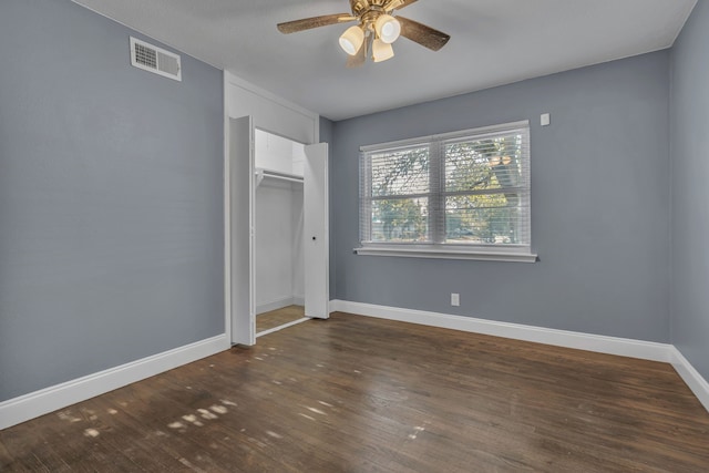 unfurnished bedroom featuring a closet, ceiling fan, and dark hardwood / wood-style floors