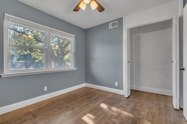 spare room featuring ceiling fan and dark hardwood / wood-style floors