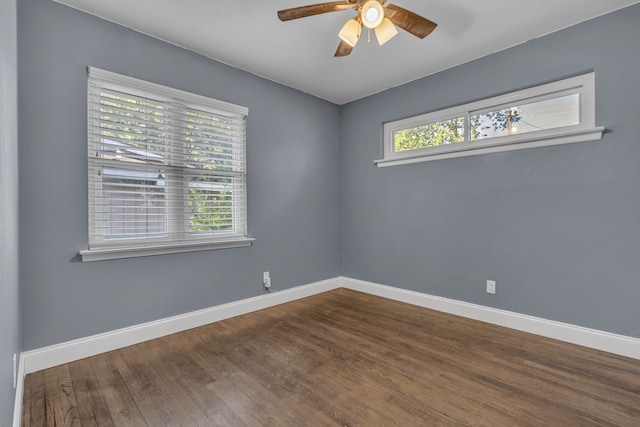 unfurnished room with dark hardwood / wood-style flooring, a wealth of natural light, and ceiling fan