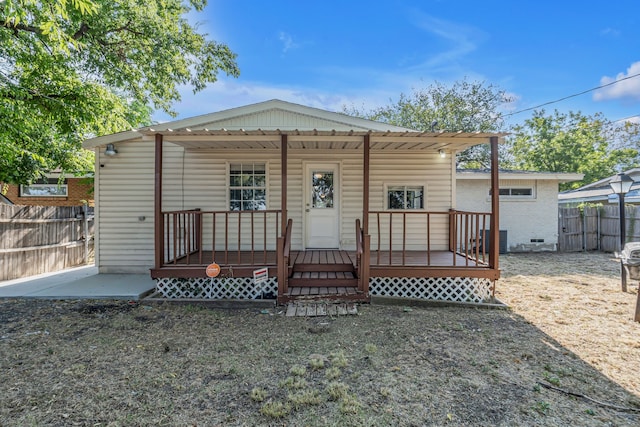 back of house with central AC unit and a wooden deck