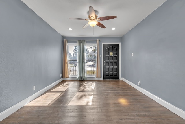 spare room with ceiling fan and dark hardwood / wood-style floors