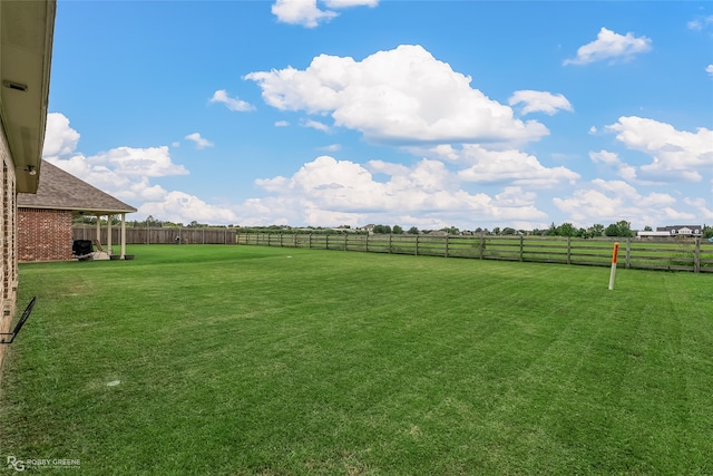 view of yard with a rural view