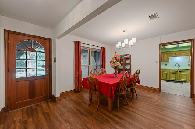 dining area with hardwood / wood-style floors, a healthy amount of sunlight, and sink