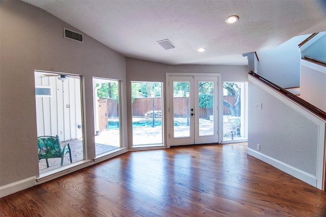 interior space with hardwood / wood-style floors, a wealth of natural light, and vaulted ceiling