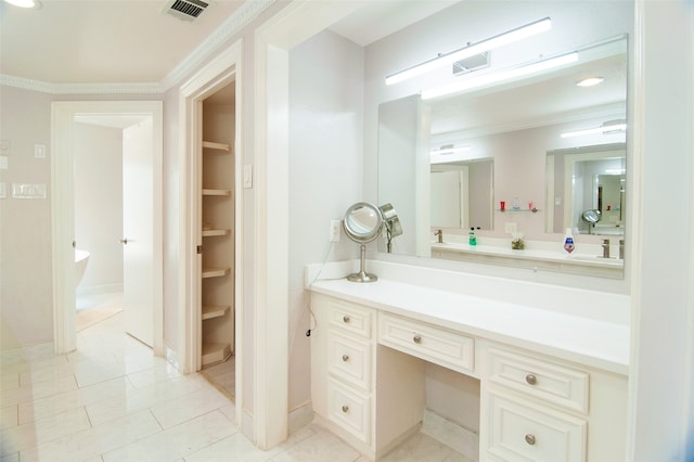 bathroom with vanity, ornamental molding, and tile patterned floors