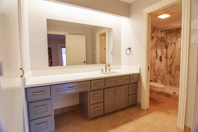 bathroom featuring tile patterned flooring, vanity, toilet, and curtained shower