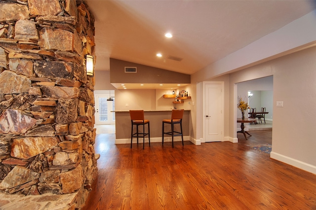 dining space with lofted ceiling and dark hardwood / wood-style floors