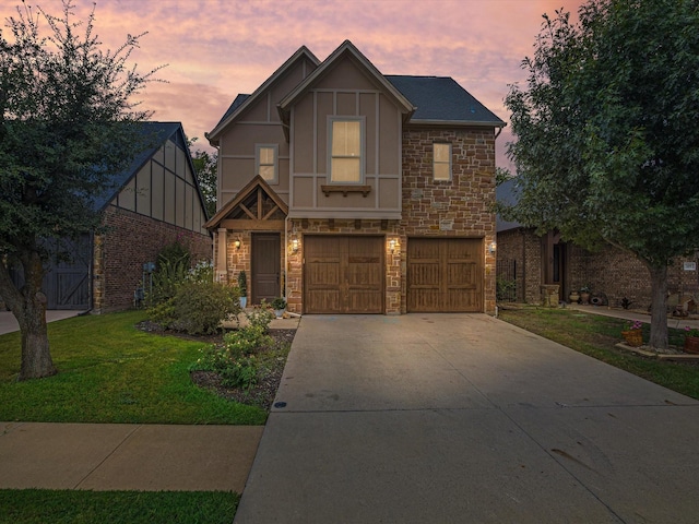 view of front of property with a lawn and a garage