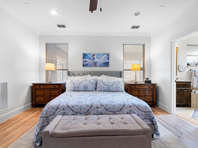 bedroom with light wood-type flooring, ceiling fan, crown molding, and connected bathroom