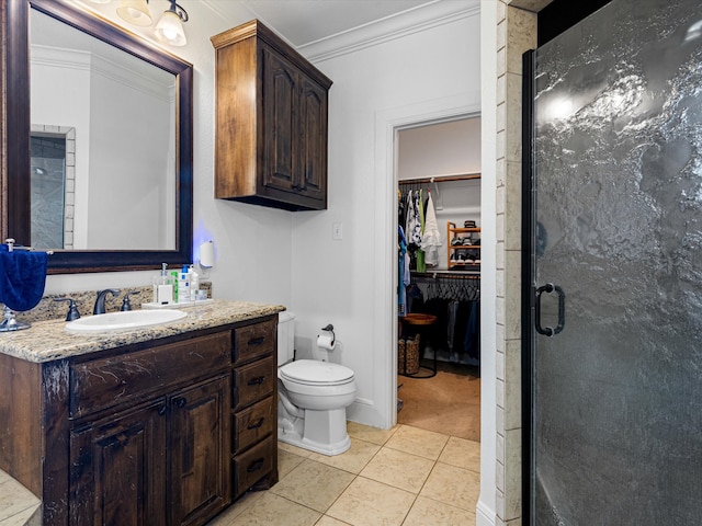 bathroom with an enclosed shower, ornamental molding, vanity, tile patterned flooring, and toilet