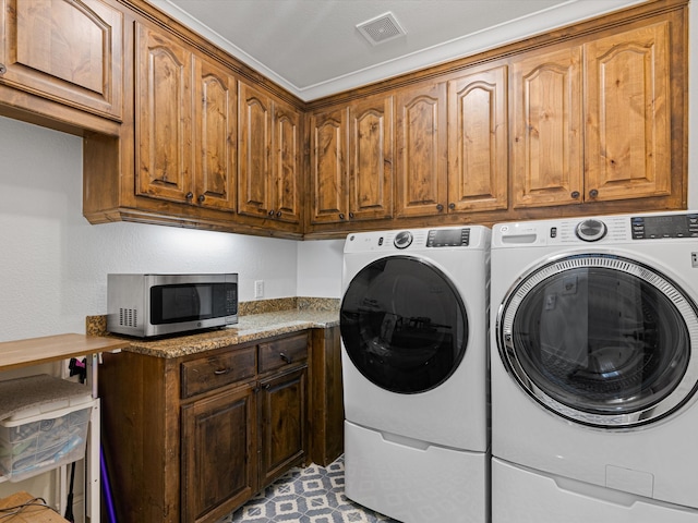 washroom with cabinets and independent washer and dryer