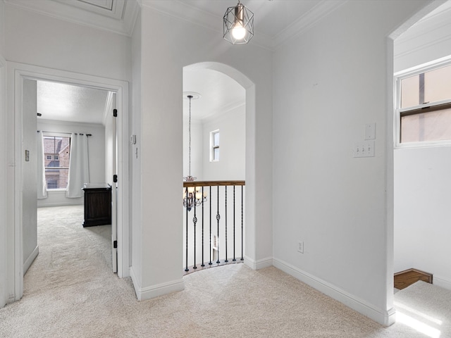 hallway with light colored carpet and ornamental molding