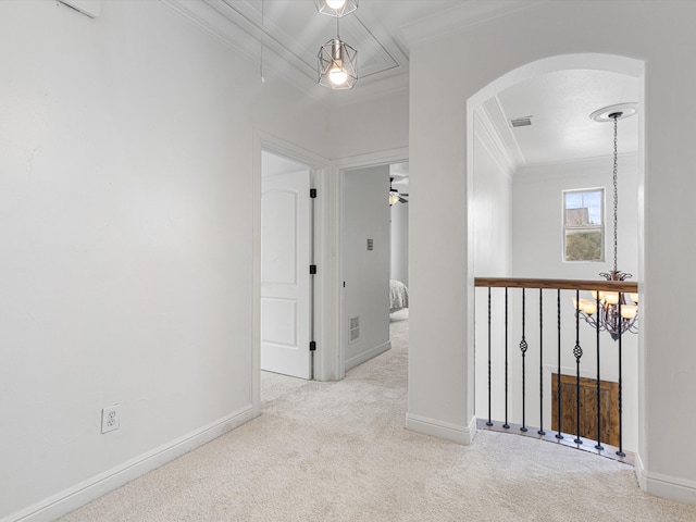 corridor featuring crown molding, light carpet, and a chandelier