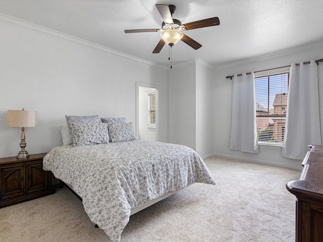 bedroom featuring ceiling fan, crown molding, light carpet, and a textured ceiling