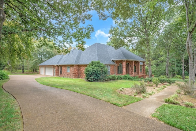 view of front of home with a garage and a front lawn