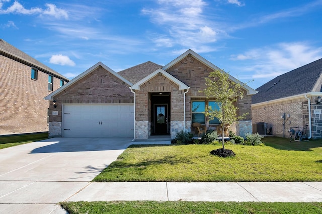 view of front of house featuring central AC unit, a garage, and a front lawn