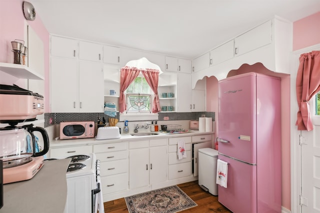 kitchen featuring sink, dark hardwood / wood-style floors, white appliances, and white cabinets