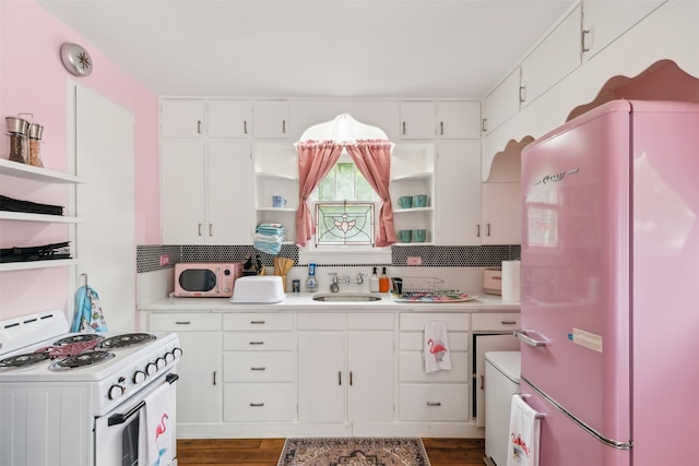 kitchen featuring white appliances, dark hardwood / wood-style flooring, white cabinetry, and sink