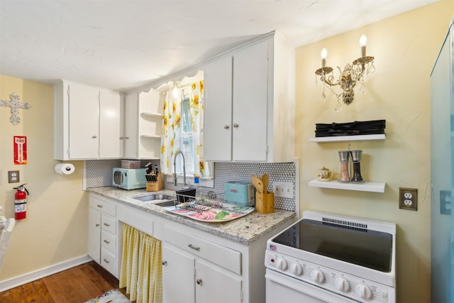 kitchen featuring white range oven, white cabinetry, dark hardwood / wood-style flooring, and tasteful backsplash