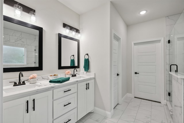 bathroom with a shower with shower door and vanity